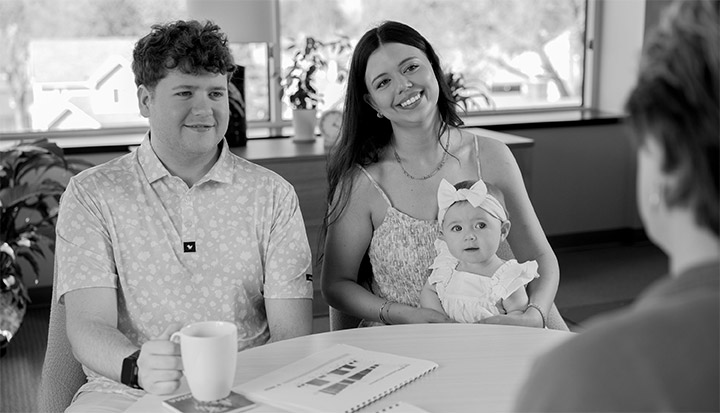 Married couple with child with financial advisor